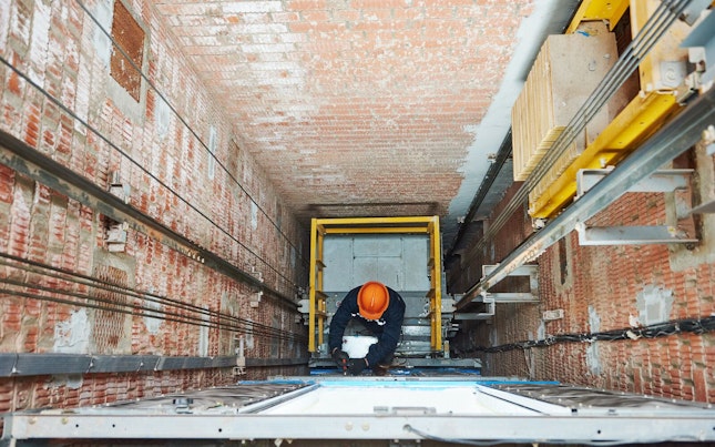 Professional Technician Checking Elevator in a Building